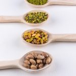 ground-milled-crushed-granulated-pistachios-wooden-spoons