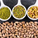 top-view-ground-milled-crushed-pistachios-bowl-gray-texture