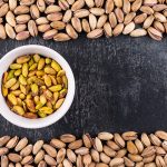 top-view-pistachios-bowl-gray-texture-with-copy-space-horizontal